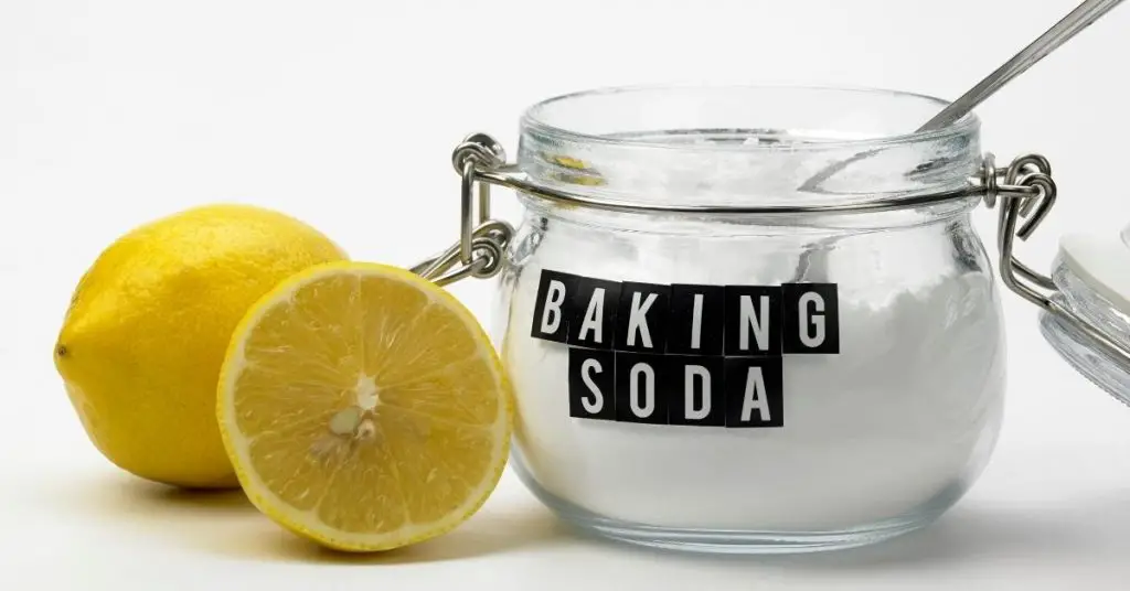 Baking soda in a glass bowl with lemons to clean - Clean and Tidy Living