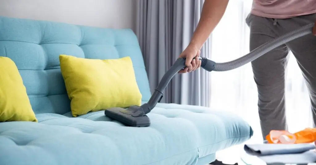 Hoovering a Blue Sofa - Best Vacuum Cleaner Under £200 - Clean and Tidy Living