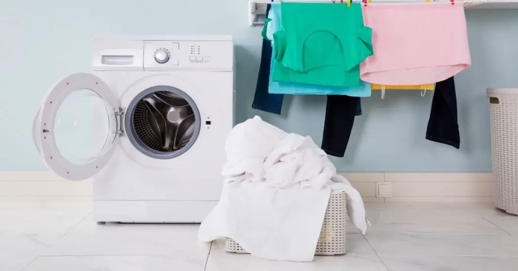 Washing Machine on a Floor with Laundry - How Much Does a Washing Machine Weigh - Clean and Tidy Living