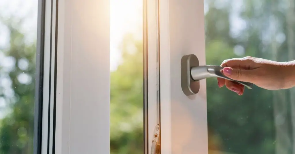 Opening a Window to Stop Your Clothes Smelling Damp - Clean and Tidy Living