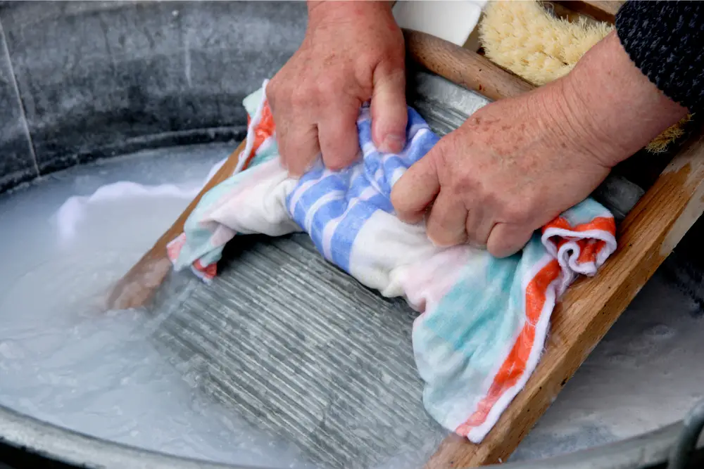 How do you wash clothes with a washboard